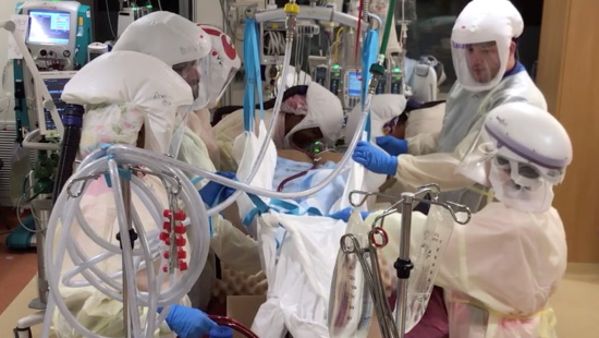 Team of healthcare workers operating advanced COVID treatment