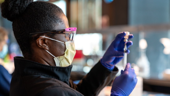 Woman draws a vaccine on the first day at M&T Bank Stadium