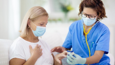 Nurse and patient wearing masks