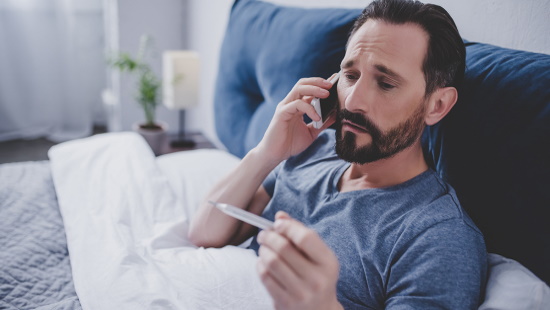 Man with fever in bed