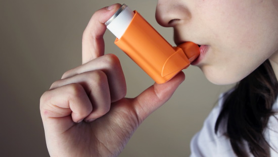 Woman using an inhaler