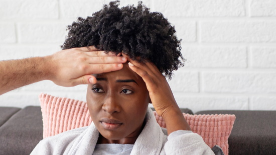 Man checking woman's temperature