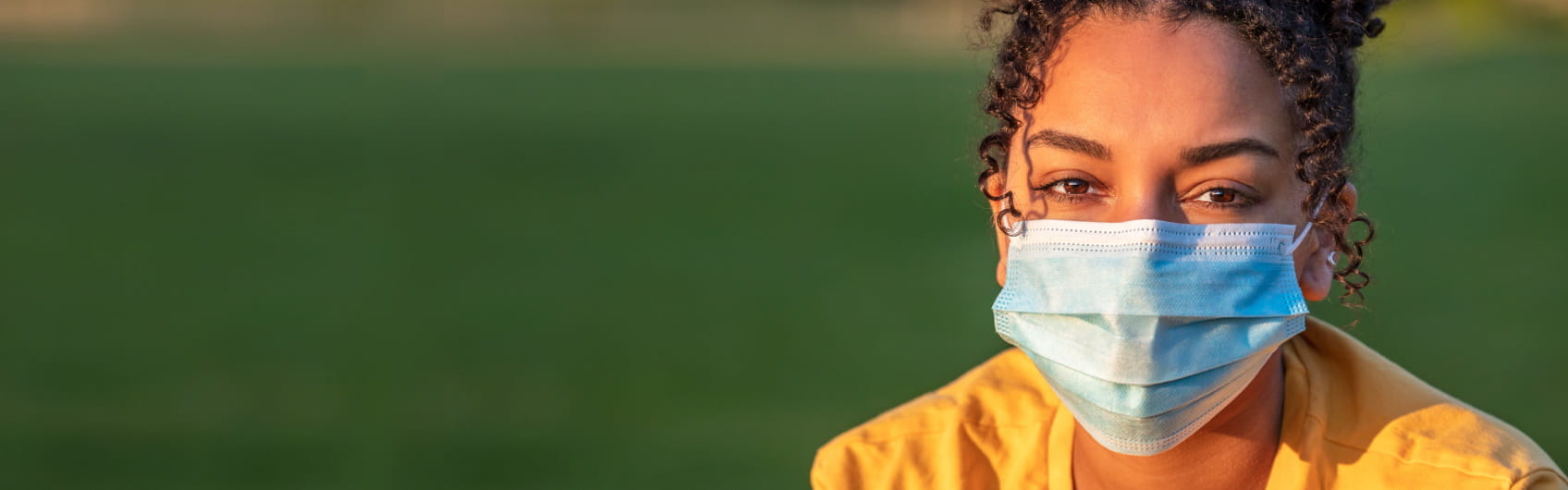 Young woman outside with mask