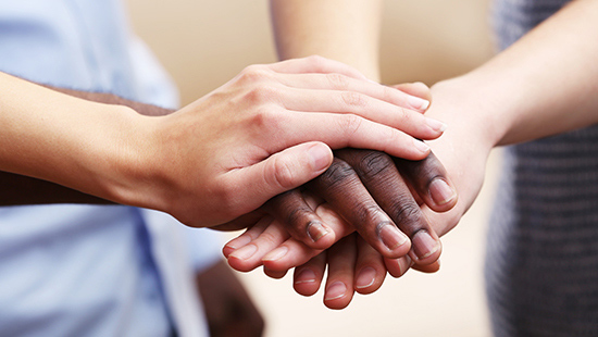 Hands hold one another in support