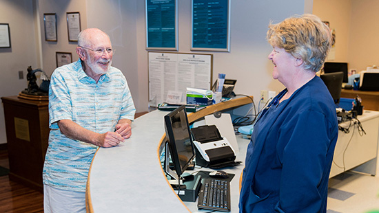 Hospital employee assisting visitor