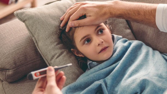 Girl having her temperature taken