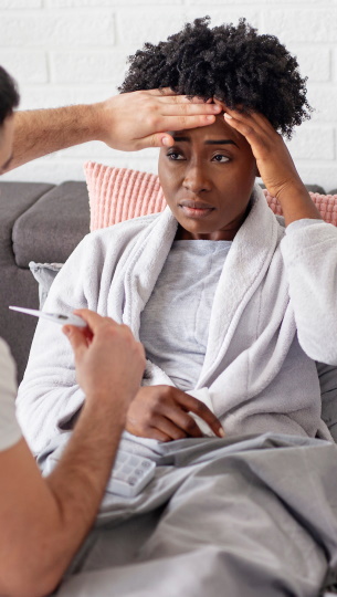 Man checking woman's tmperature