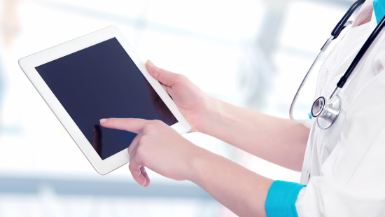 Woman with stethoscope holding computer tablet