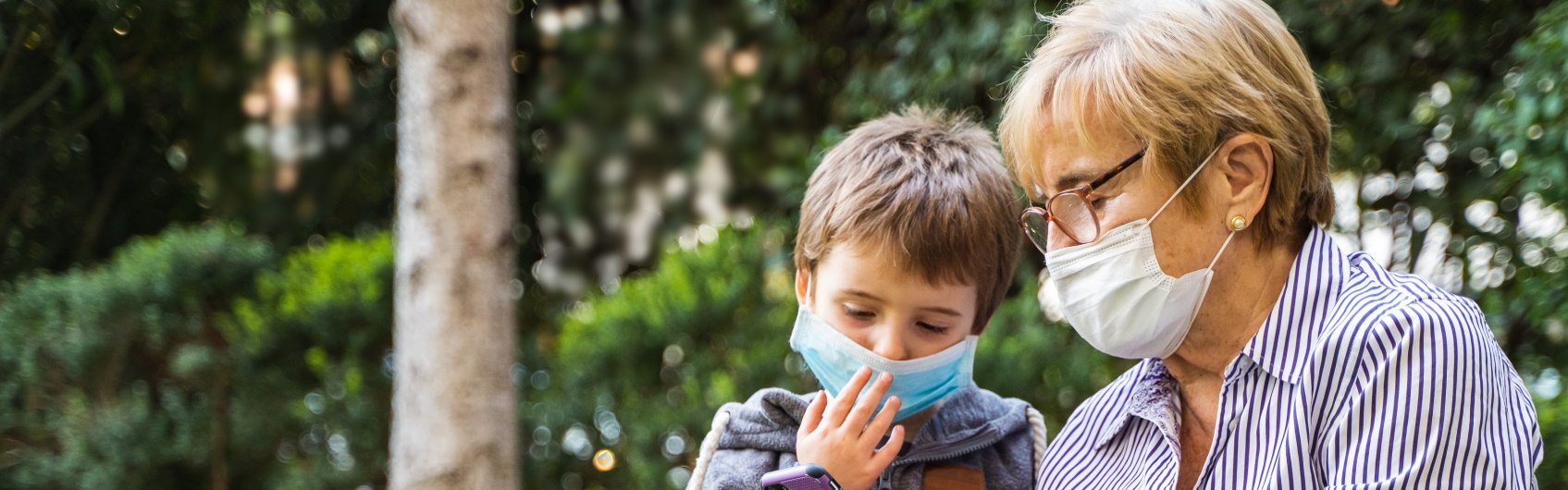 Grandmother and grandson wearing masks