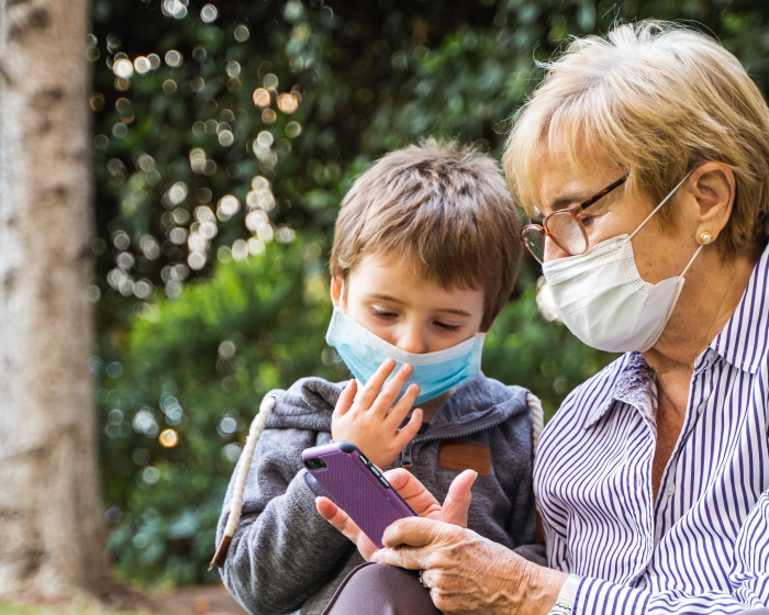 Grandmother and grandson wearing masks