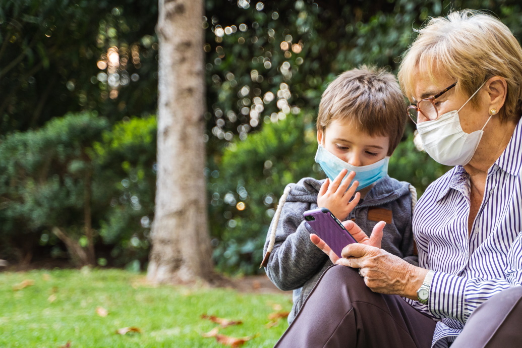 Grandmother and grandson wearing masks