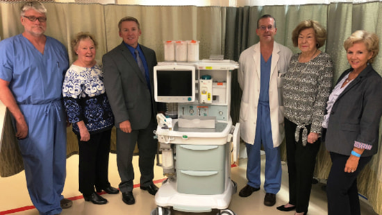 Hospital officials, foundation members and staff stands with new equipment