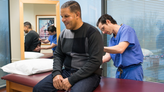 Dr. Ludwig examining a patient's spine