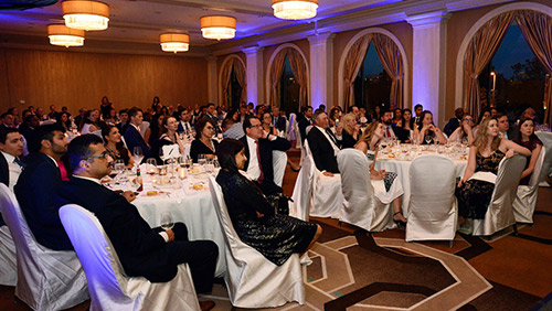 A room full of people at a resident graduation