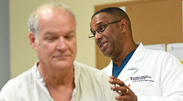 Dr. Bethel inspecting a patient's back