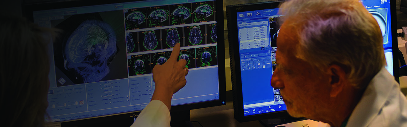 Dr. Howard Eisenberg looking at brain scans