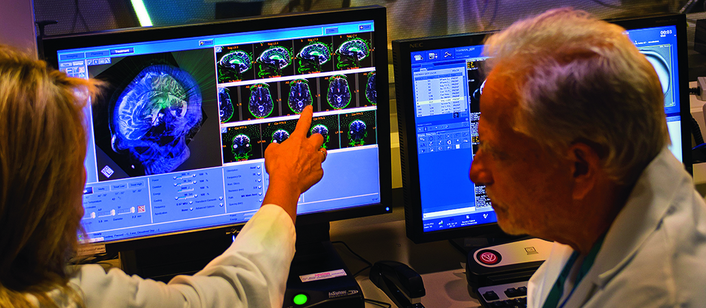 Dr. Howard Eisenberg looking at brain scans