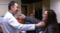 Dr. Charles Sansur hugging a patient