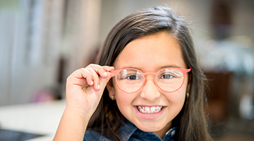 A young girl wearing glasses