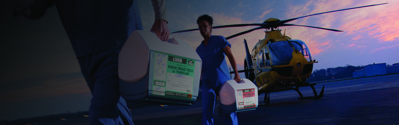 Transplant nurses transporting organs from a helicopter to the hospital