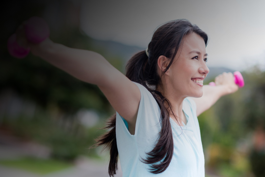 Smiling woman lifting hand weights
