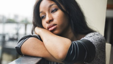 Sad woman leaning on a railing